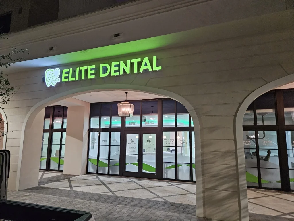 The Elite Dental Touch sign lit up at night