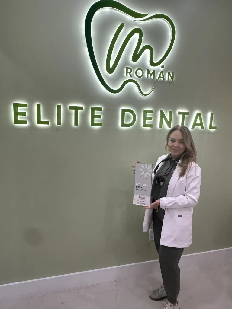 Dr. Maria A. Roman holding the Invisalign Silver Provider award